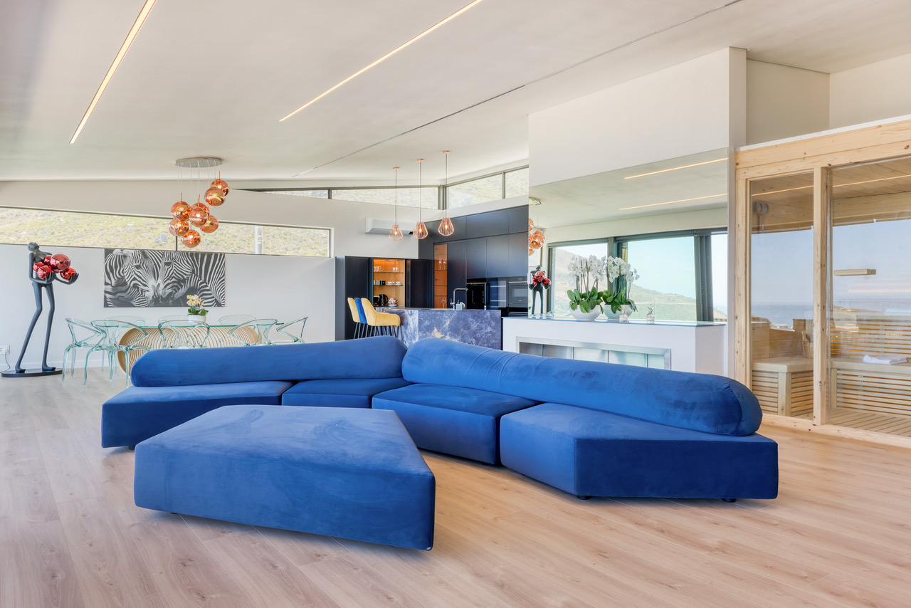 Penthouse living room with sculptural seating and ocean outlook