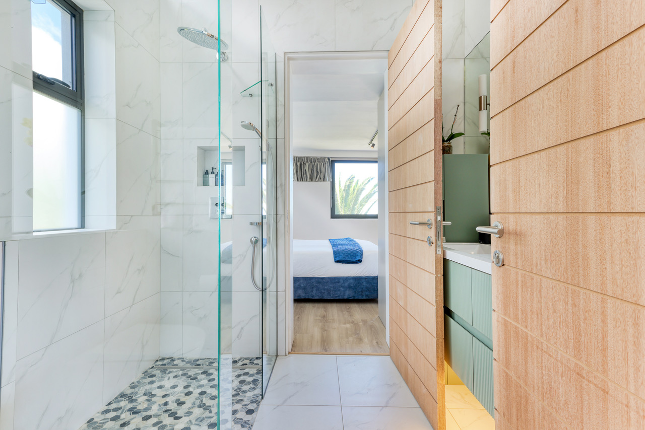 Refined penthouse bathroom finished in marble tones